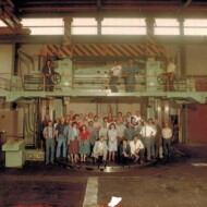 The whole crew including the boss, the foreman, and the office staff, lined up on the big vertical lathe. Allied Engineering staff photo marked